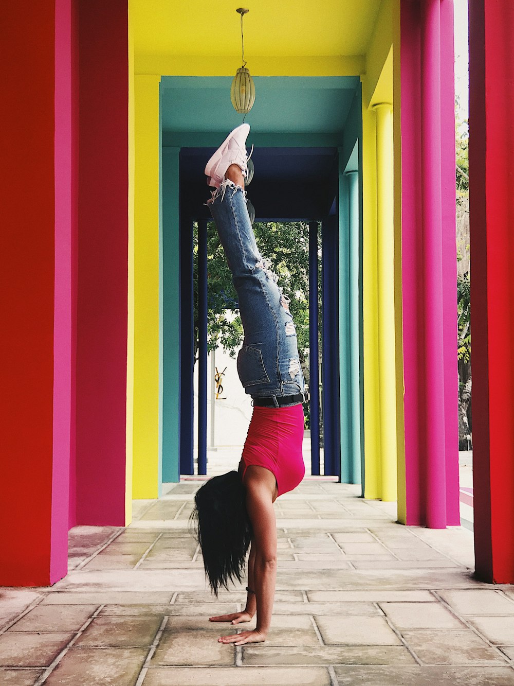 woman standing using hands near yellow wall