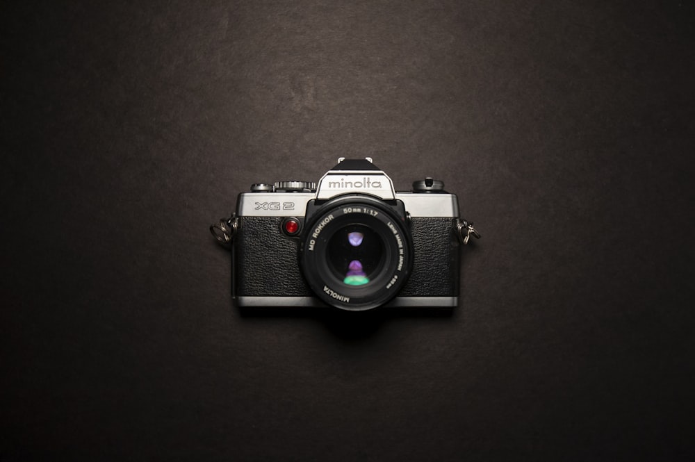 black and grey Minolta film SLR camera