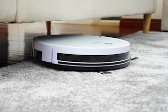 A sleek Sweepora vacuum cleaner in action, effortlessly picking up dust from a hardwood floor.