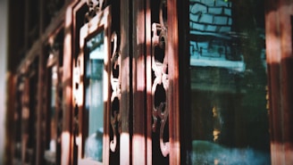 Close-up of a finely crafted wooden window frame glowing in natural light.