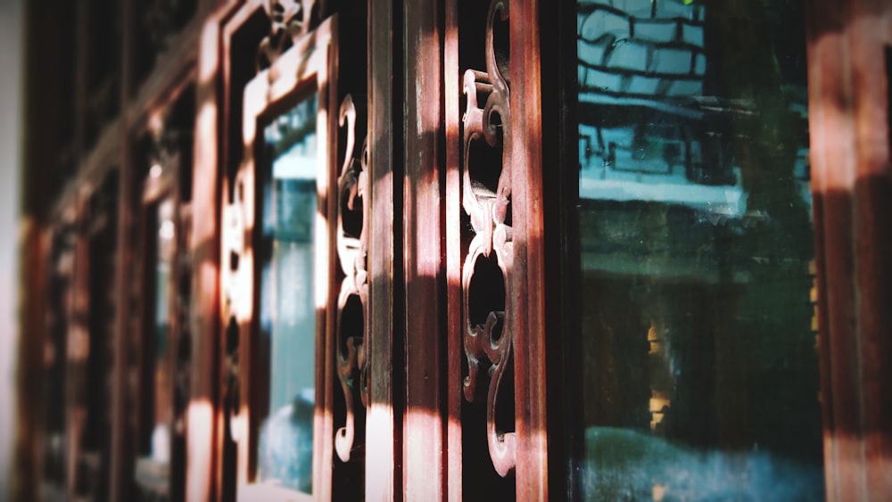 a close up of a wooden door with a building in the background