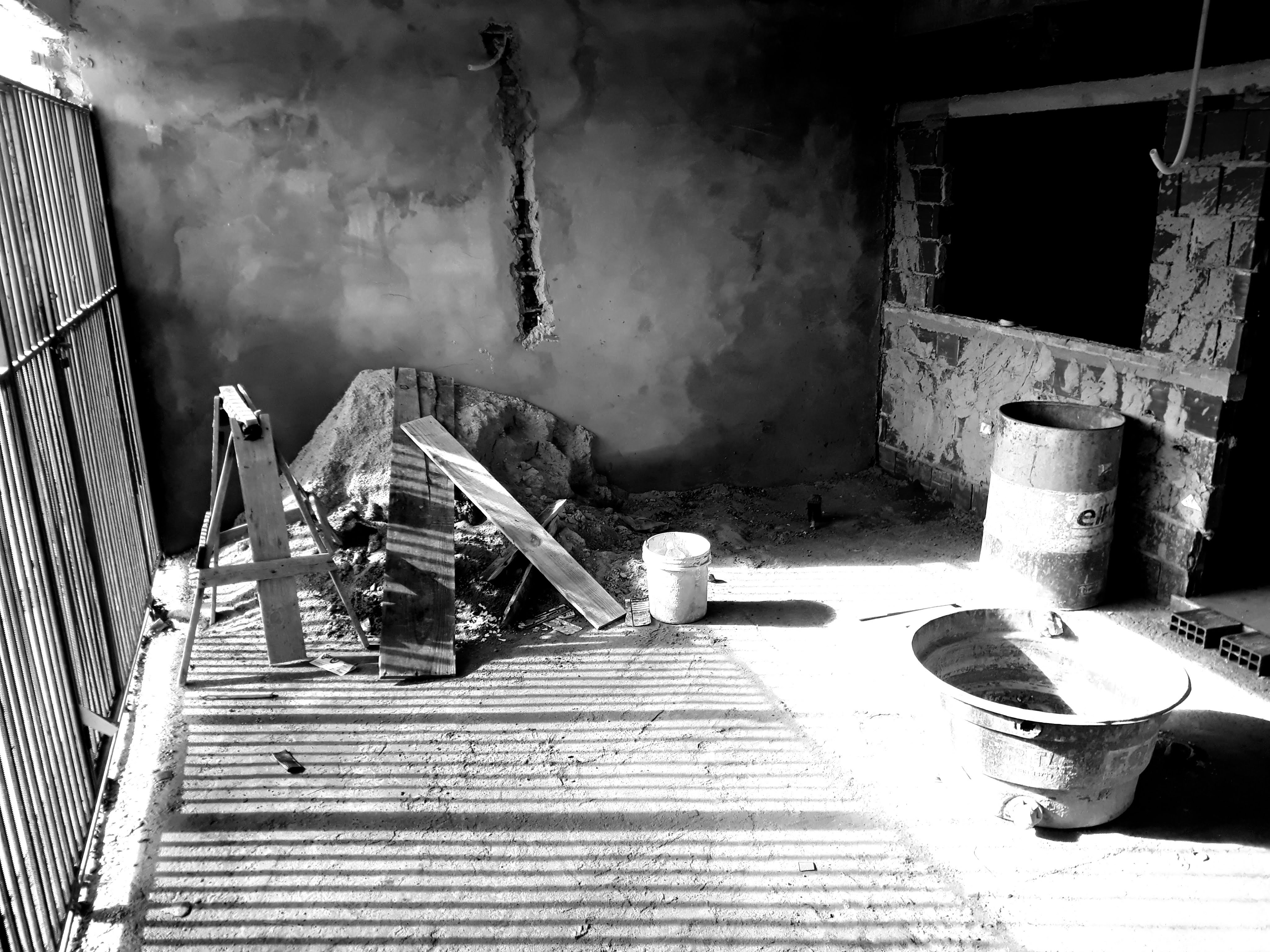 Concrete blocks and masonry tools on construction site with dramatic shadows