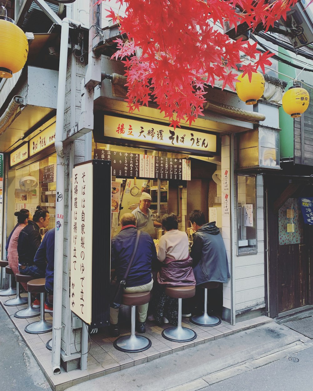 people sitting in food stall