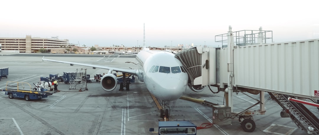 few people near airplane beside shipping container,