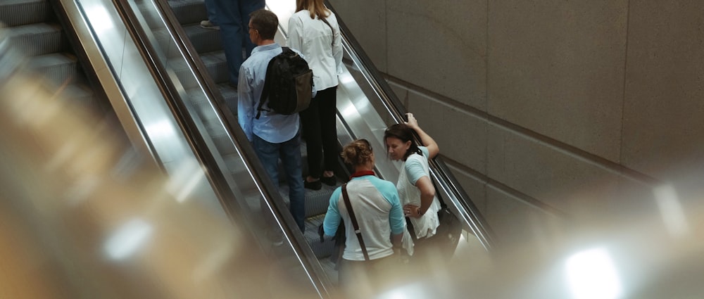 people standing on escalator