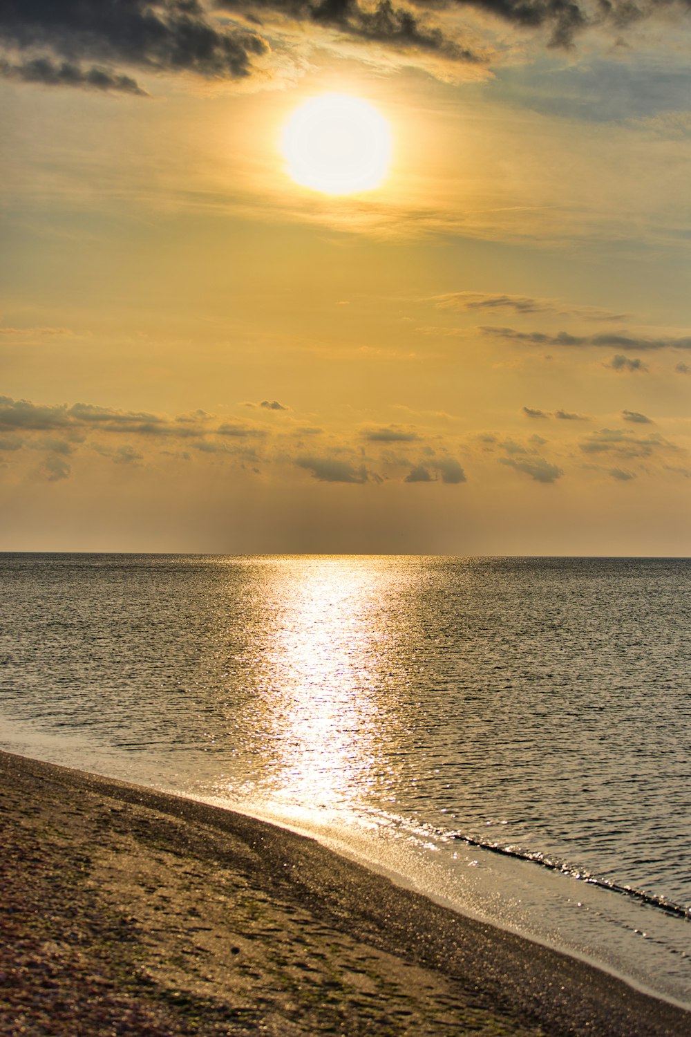 body of water under grey clouds