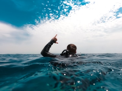 a scuba diver on the surface doing a Shaks sign