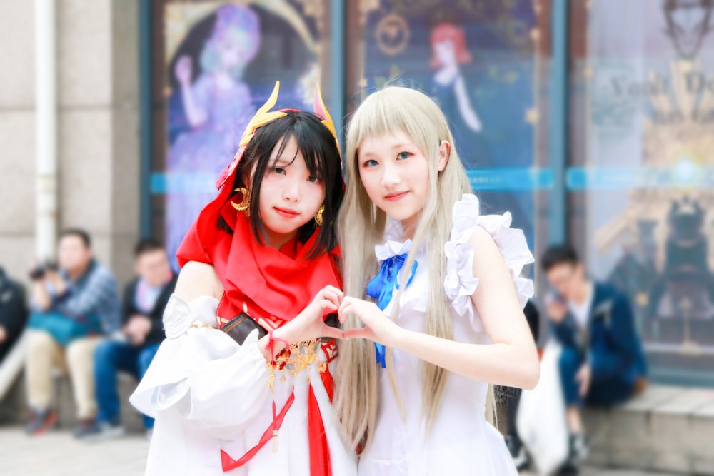 two girl wearing white dress