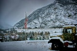 yellow truck near hills