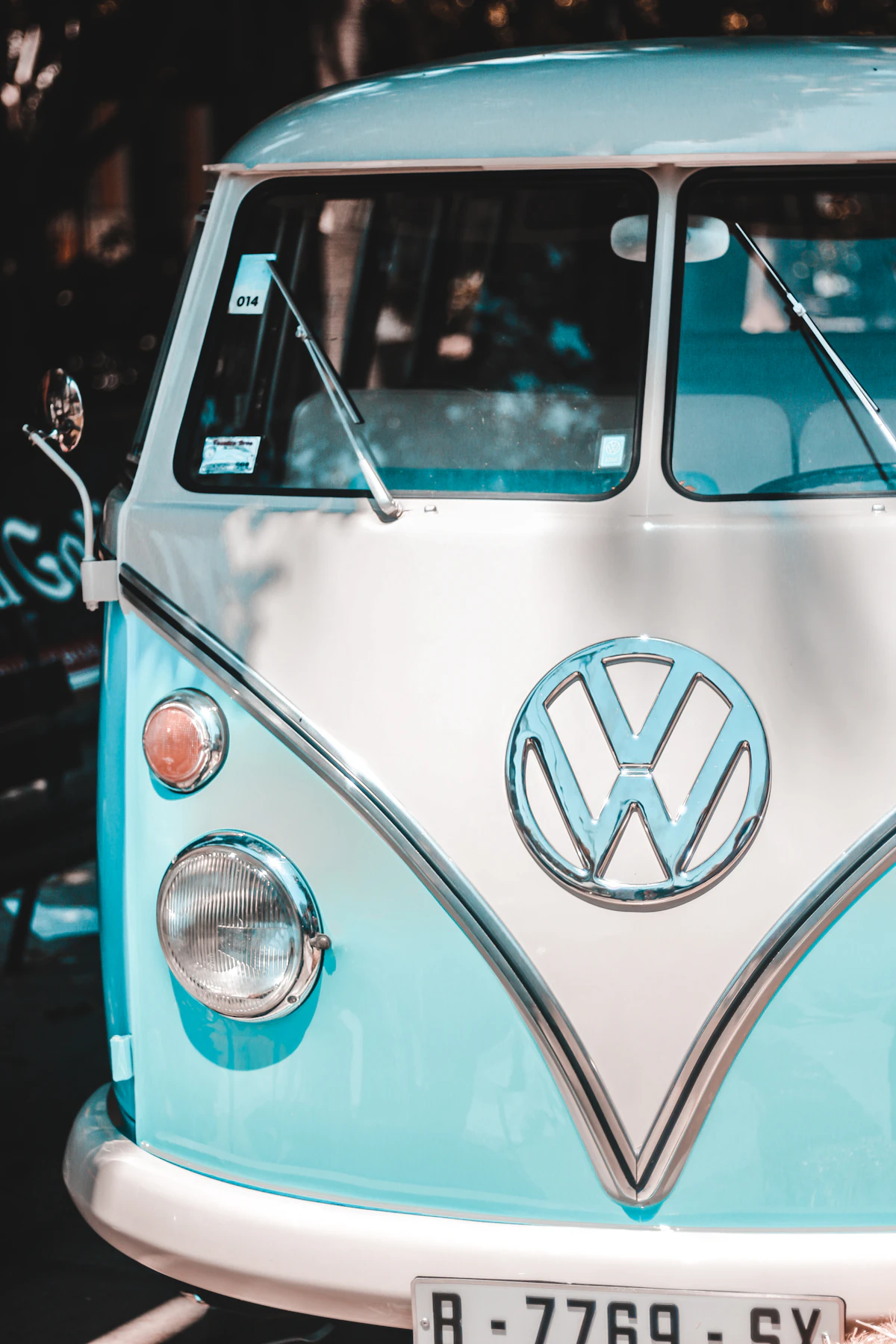 Front of a restored teal and white Volkswagen T1 bus