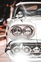 Close-up of a polished headlight and clean bonnet of a trusted older vehicle, highlighting its well-maintained condition.