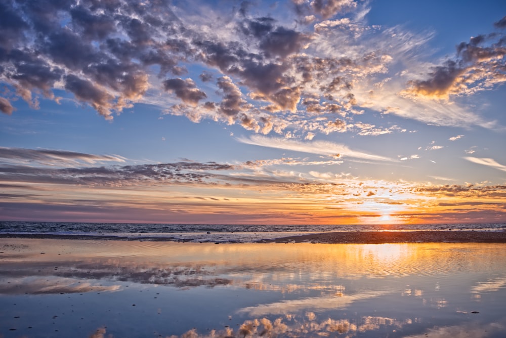 calm body of water during sunset