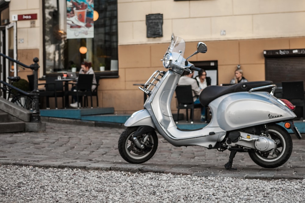 gray motor scooter parked outdoor during daytime