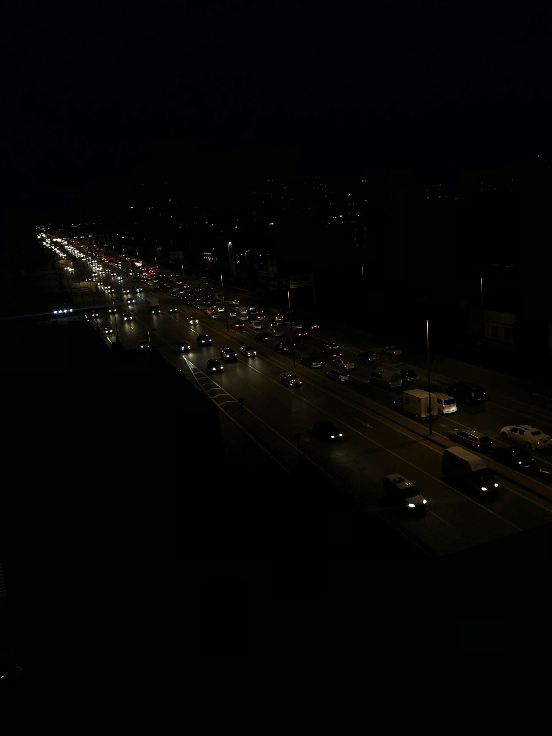 a city street at night with a lot of traffic