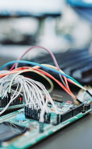 person using computer keyboard near green circuit board