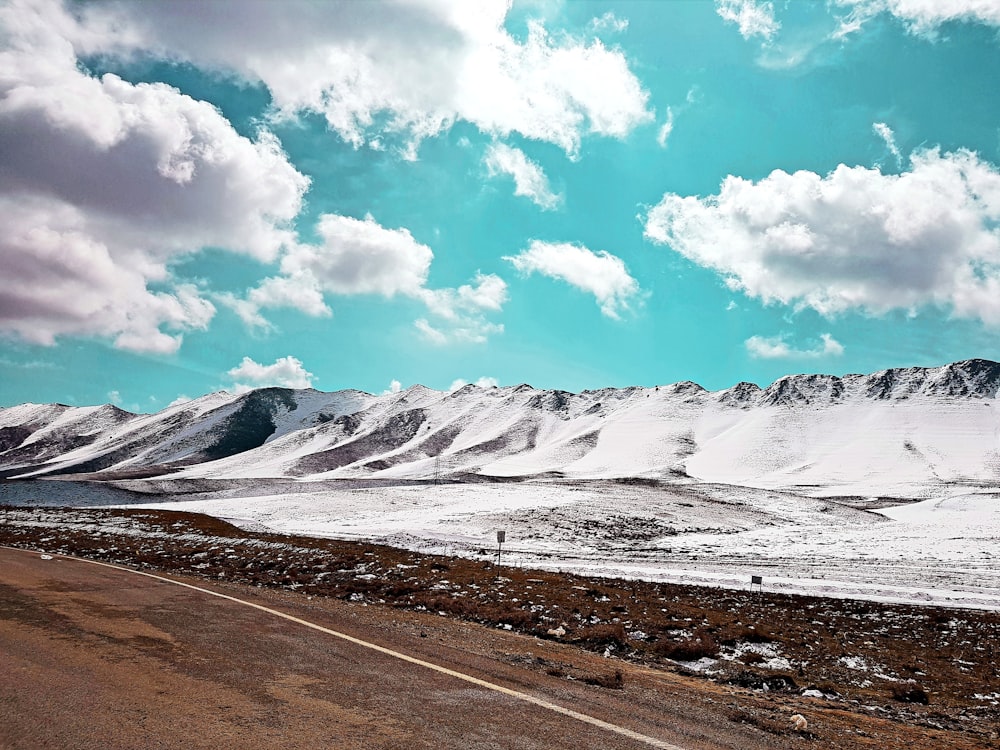 snow covered rock formation under white and blue sky