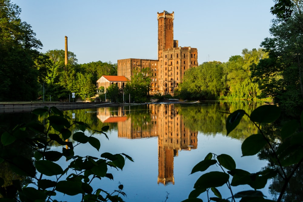 brown building near calm body of water