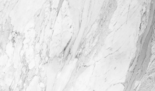 a close up of a white marble wall