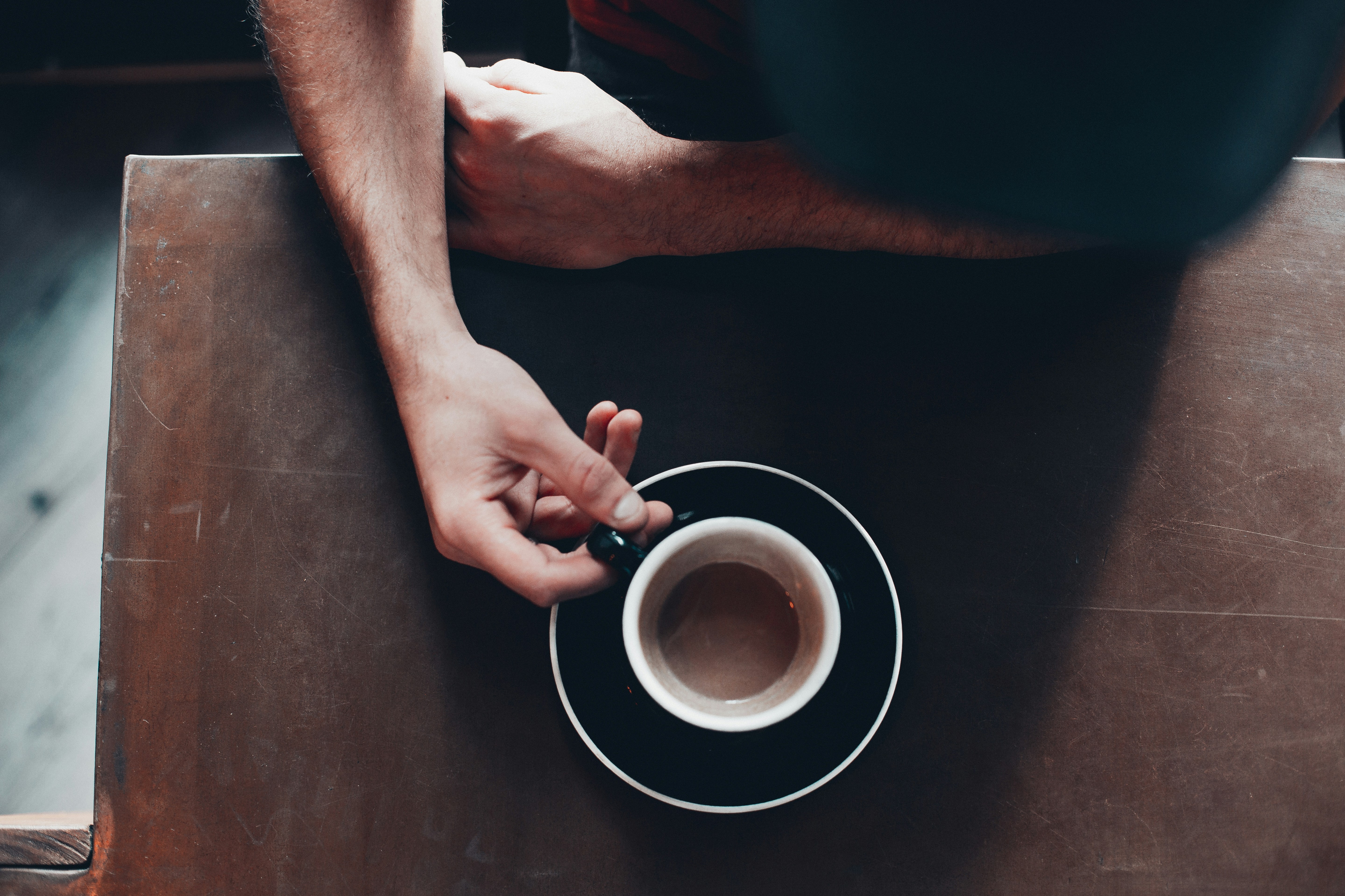 person holding white mug