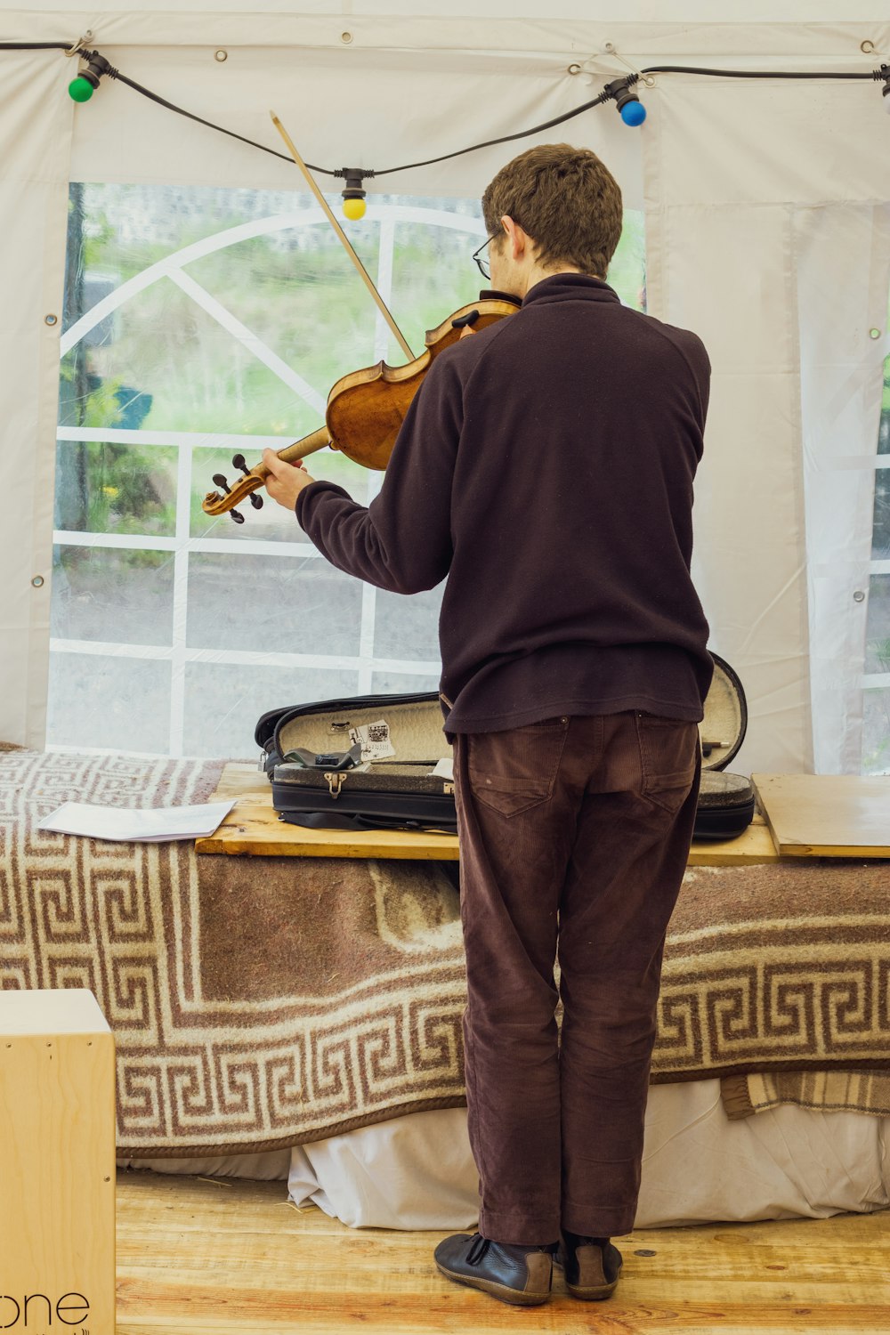 man playing violin in room