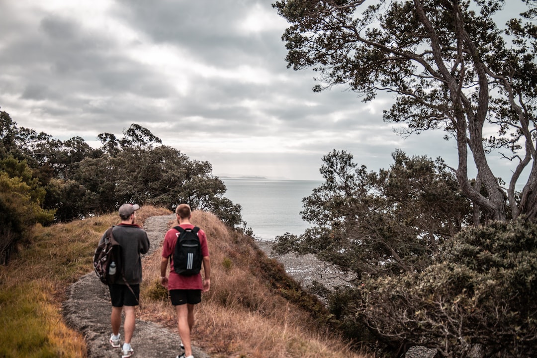 two people walking on dirtpath