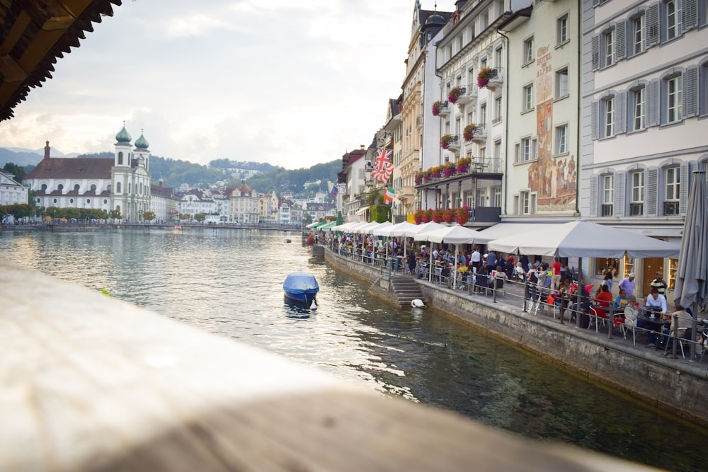 people sitting near tables near river