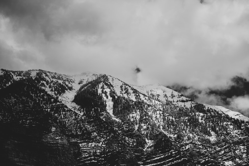 snow covered mountain under white clouds