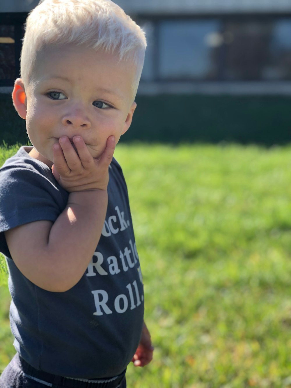 boy standing on grass field