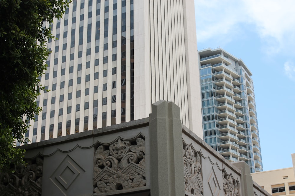 white concrete high-rise buildings under blue and white skies