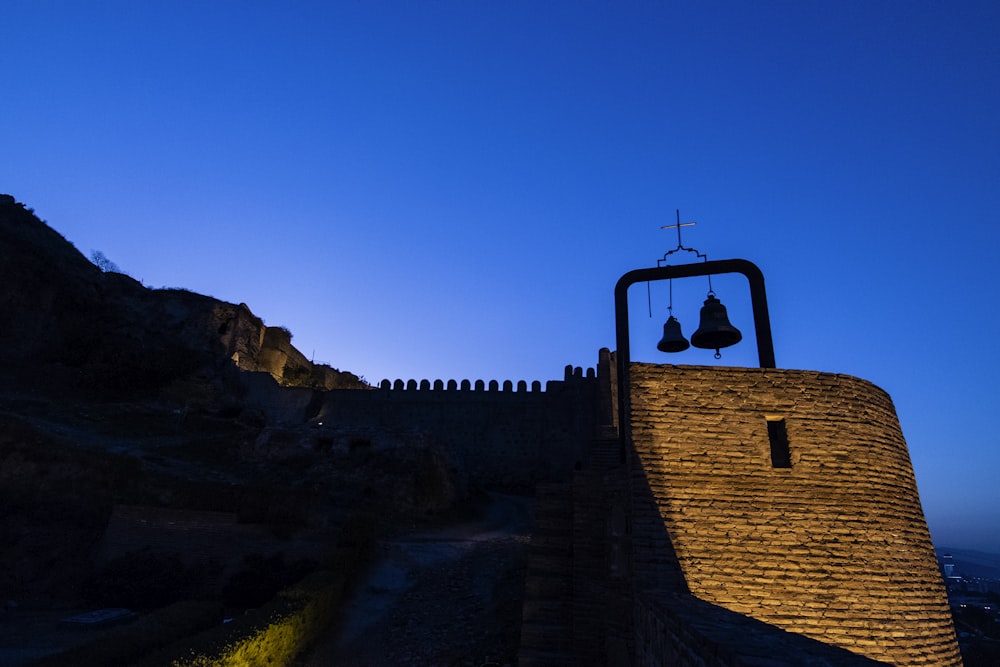 a bell on top of a stone wall