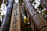 A close-up of several bamboo stalks, one of which has Japanese text inscribed on it. The bamboo appears tall and sturdy, with the background slightly blurred, creating a contrasting depth of field effect. The lighting highlights the texture and natural colors of the bamboo.