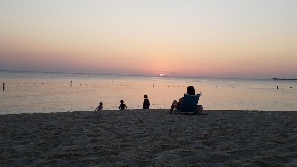person sitting on lounger facing beach