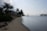 Sunny beachfront with modern holiday homes and calm sea under a clear sky.
