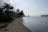 Sunny beachfront with modern holiday homes and calm sea under a clear sky.