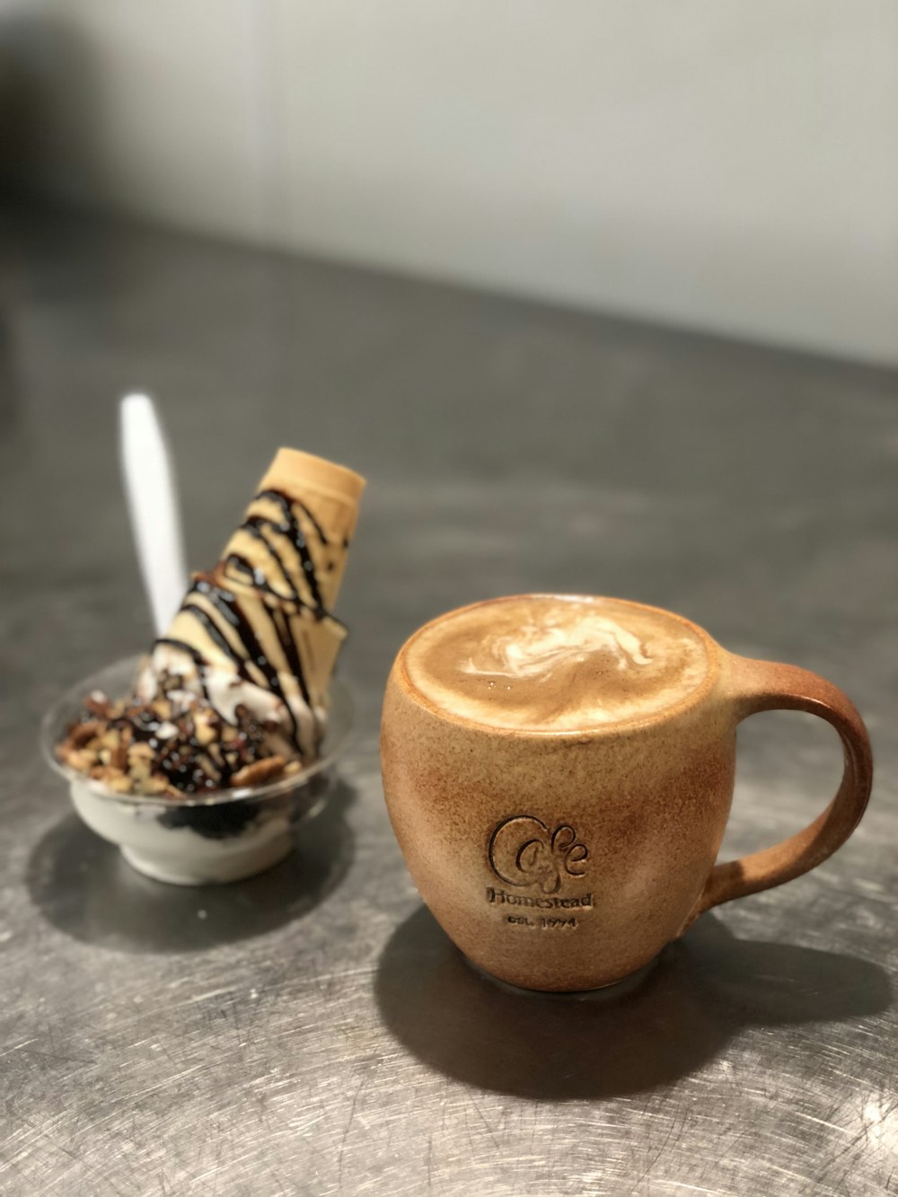 food photography of brown mug with coffee next of chocolate ice cream with cone