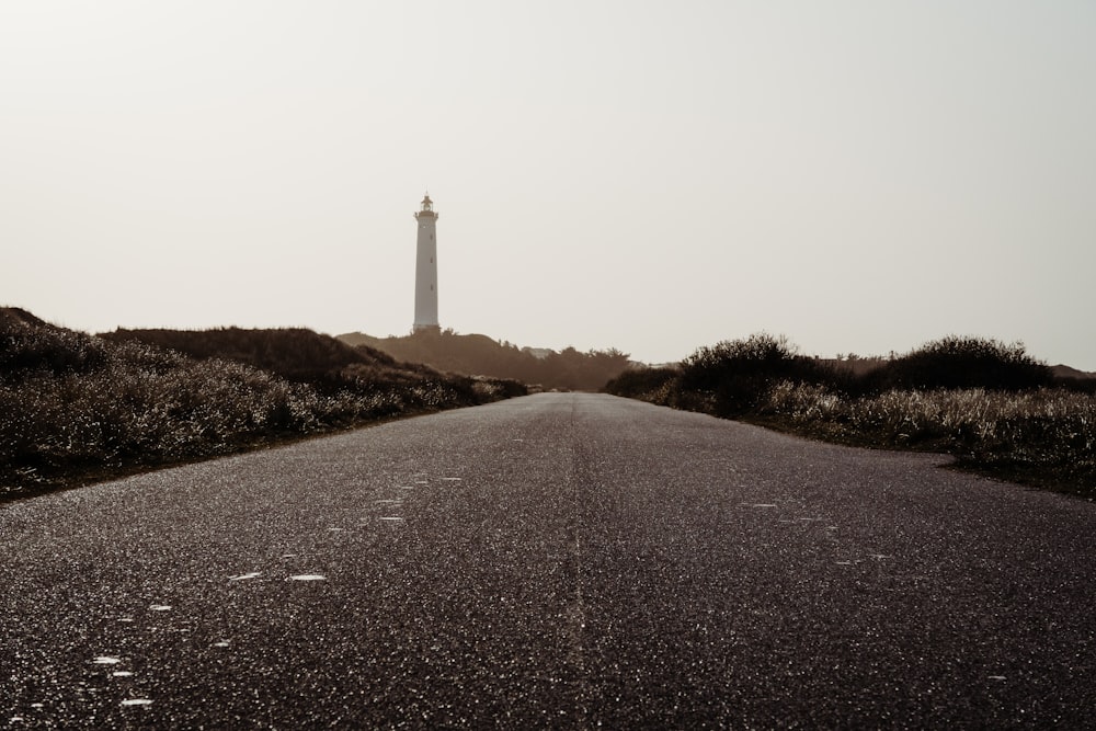 empty road near lighthouse tower