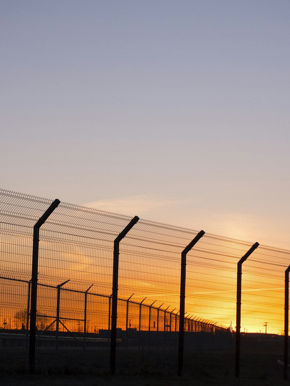 grey stainless steel fence during golden hour