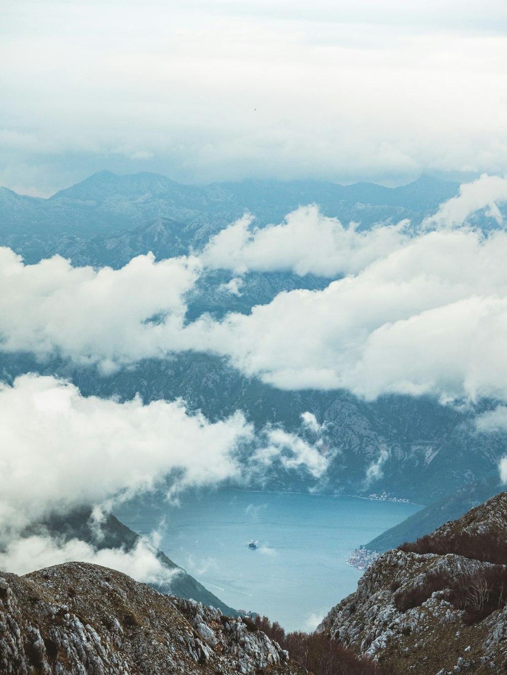 aerial view of mountains under white clouds