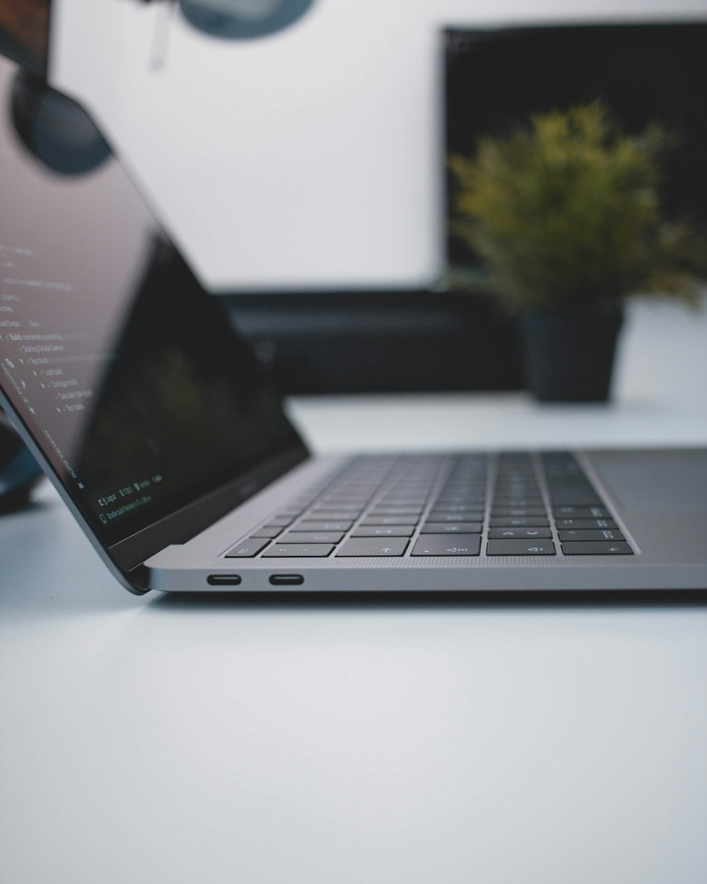 gray laptop computer on white table