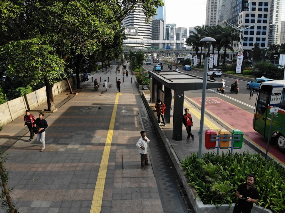 people standing on waiting shed during daytime