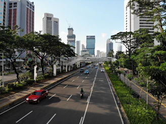 Wide 130-meter road near the project with smooth traffic flow and green landscaping along the sidewalks.