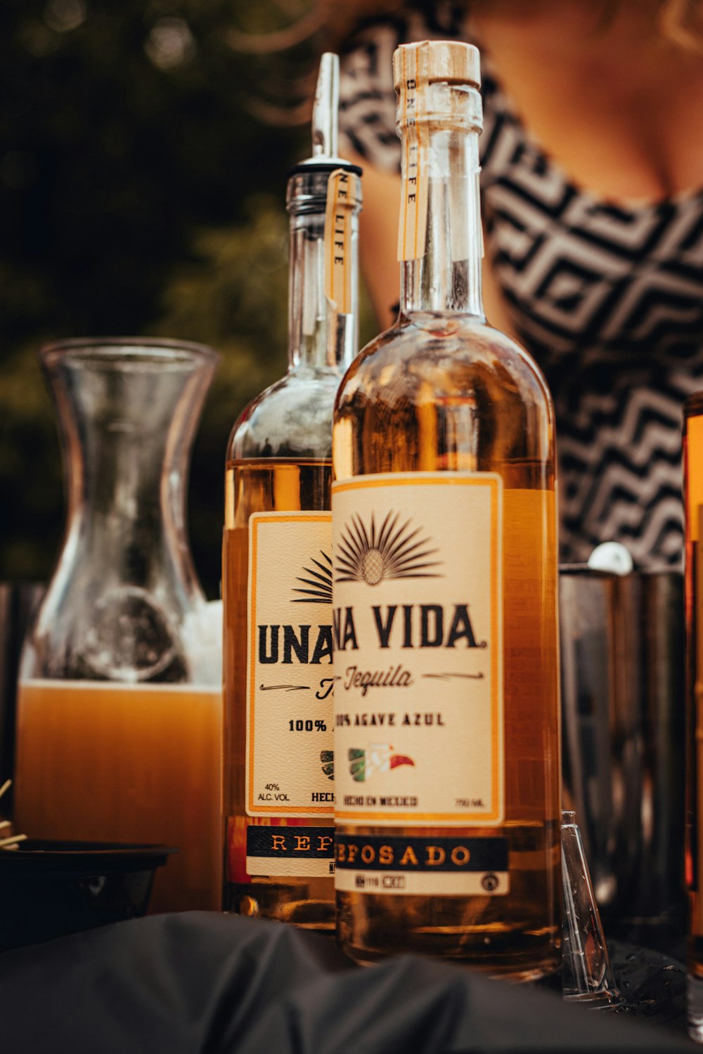 two Una Vida glass bottles