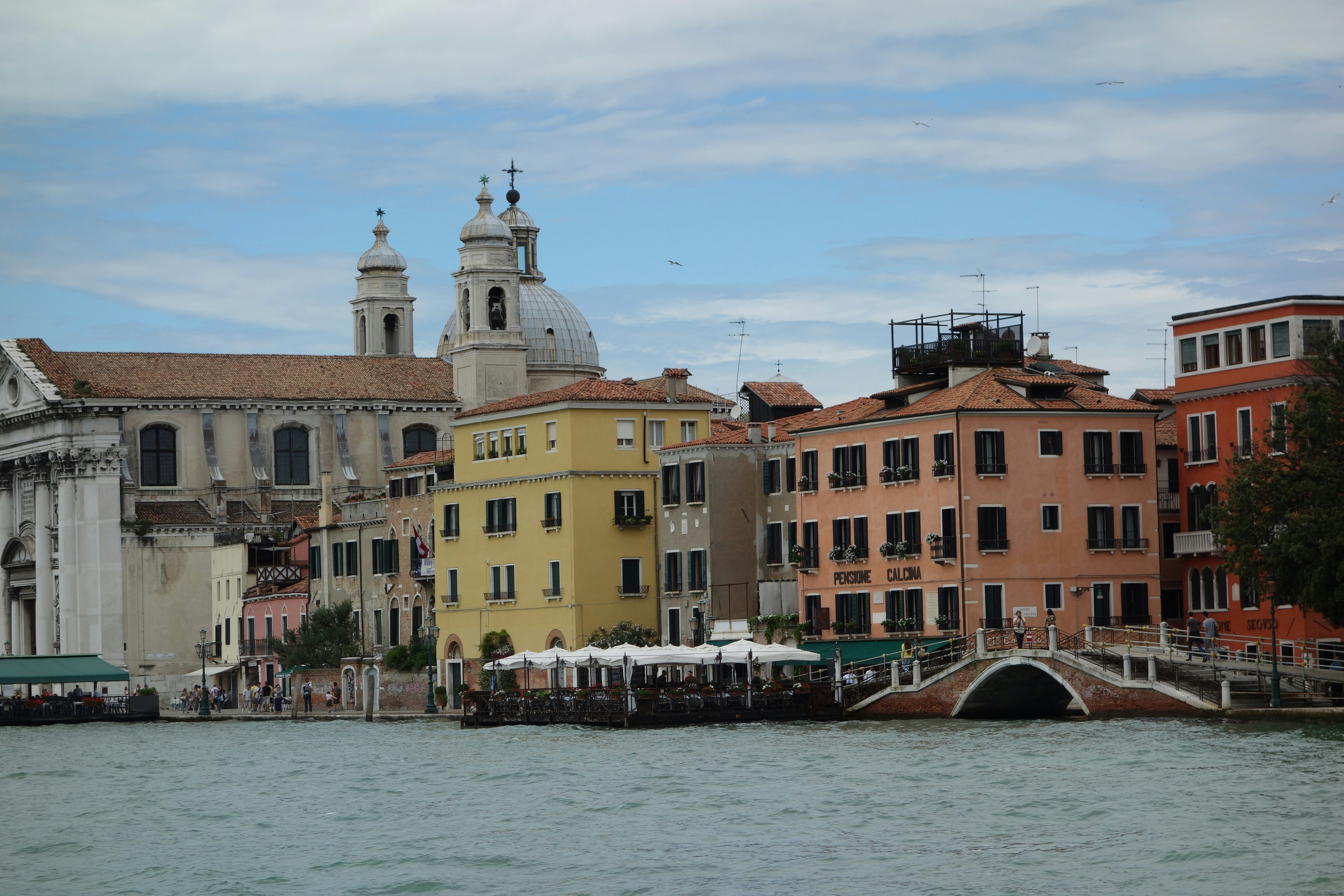 concrete buildings near body of water during daytime