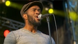 man in gray shirt singing
