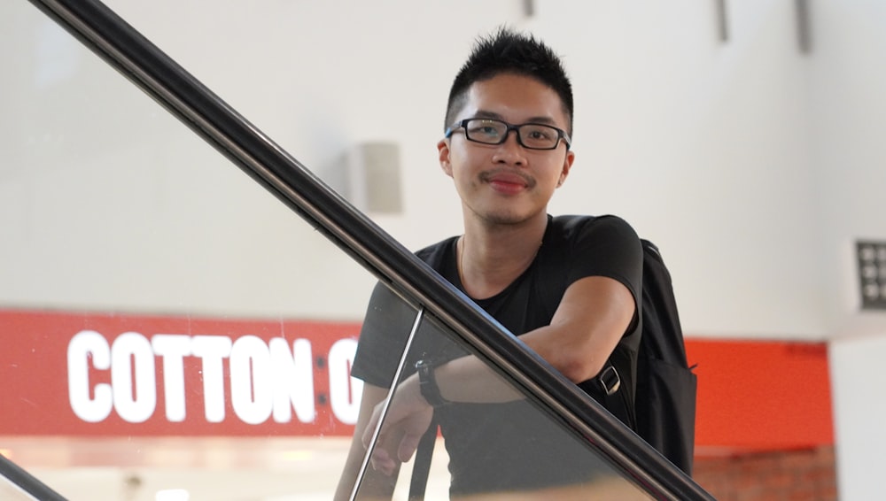 smiling man standing on escalator