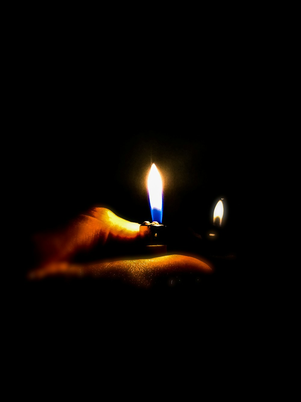 person light up the lighter on dark room