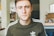 man wearing black adidas crew-neck shirt