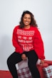 woman in red sweatshirt and black pants