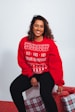 woman in red sweatshirt and black pants
