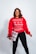smiling woman wearing red sweater and black pants